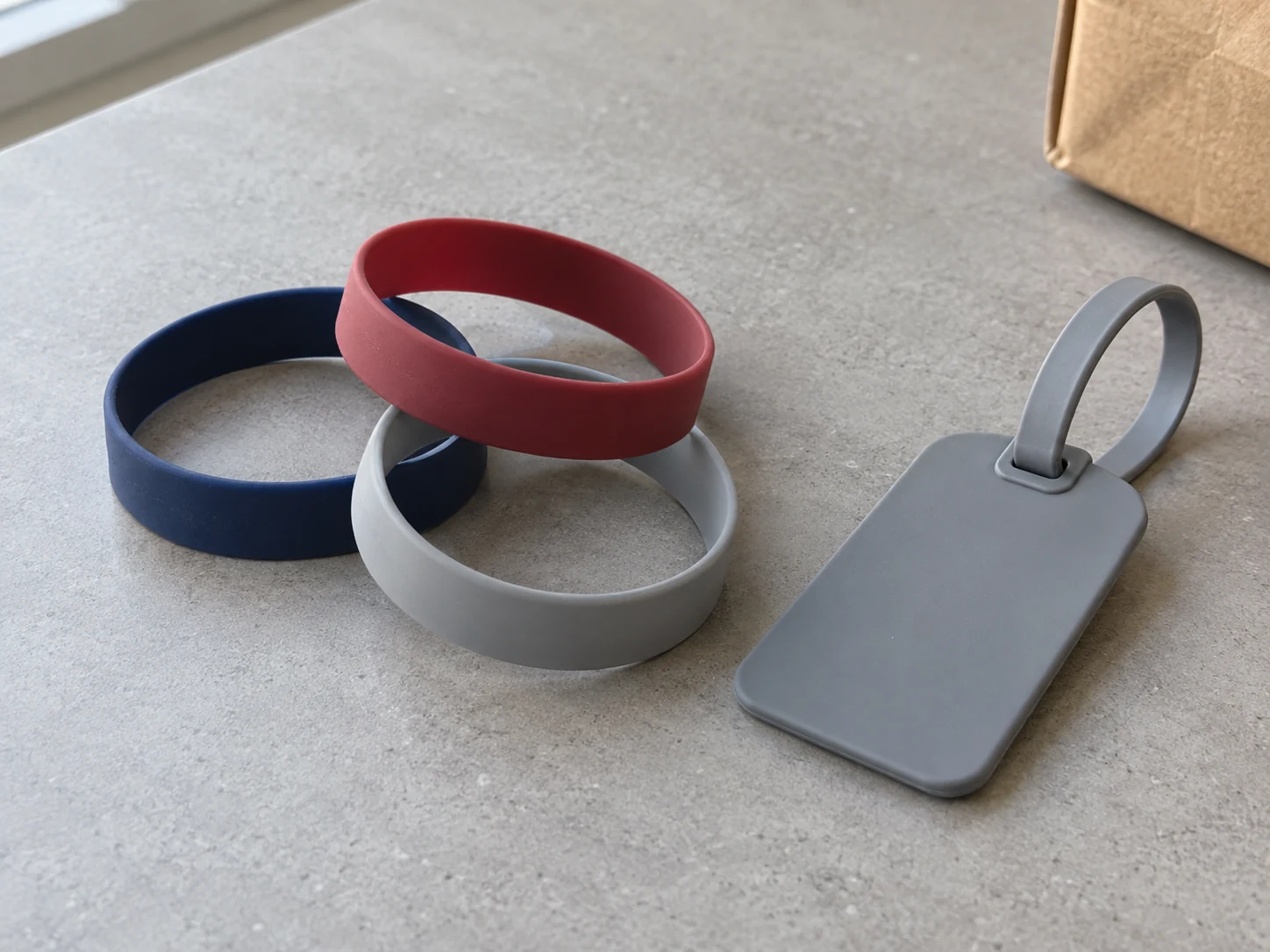 Navy, red and gray silicone wristbands with a plain luggage tag
