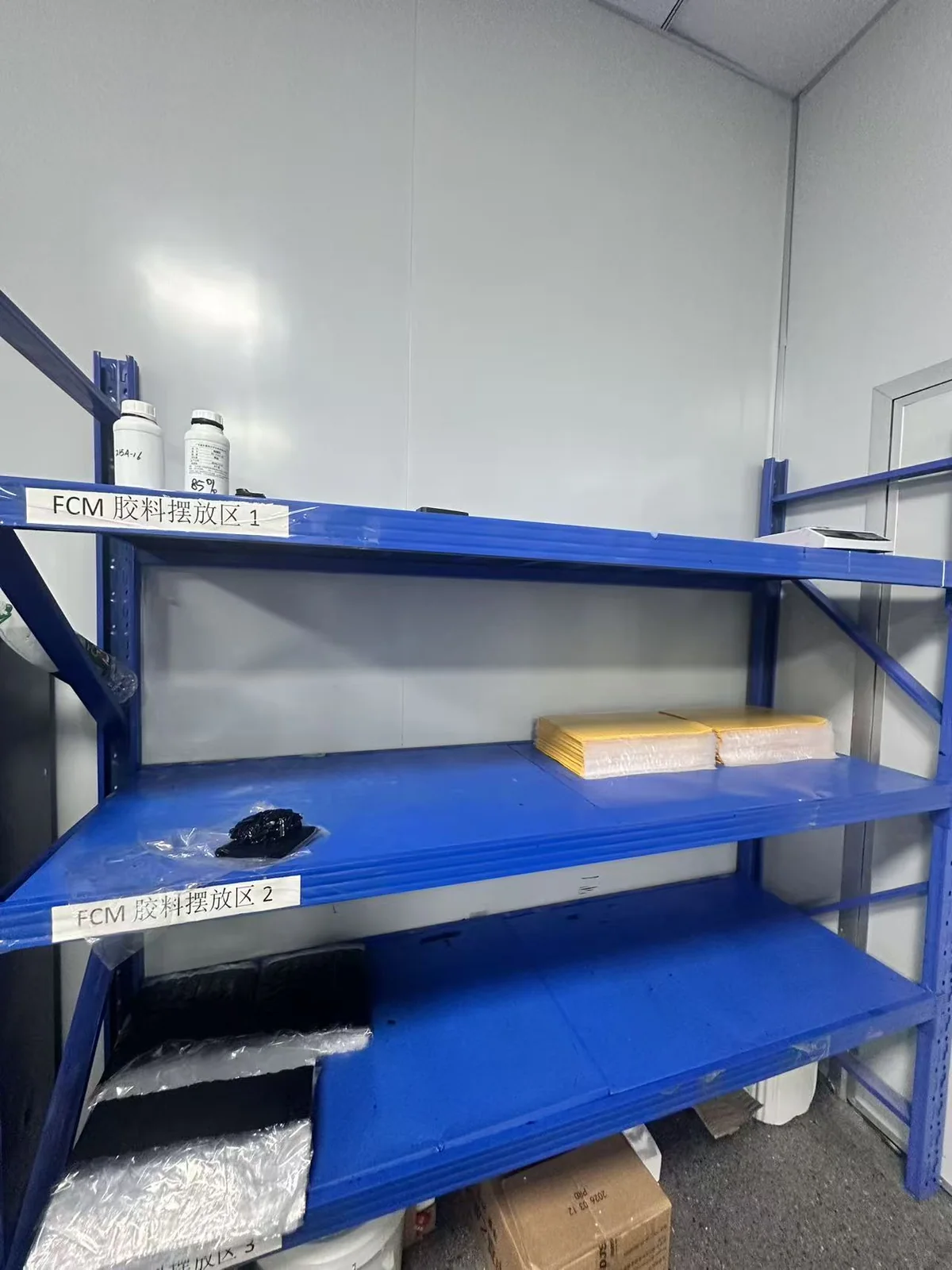 Wrapped materials on labeled blue storage shelves
